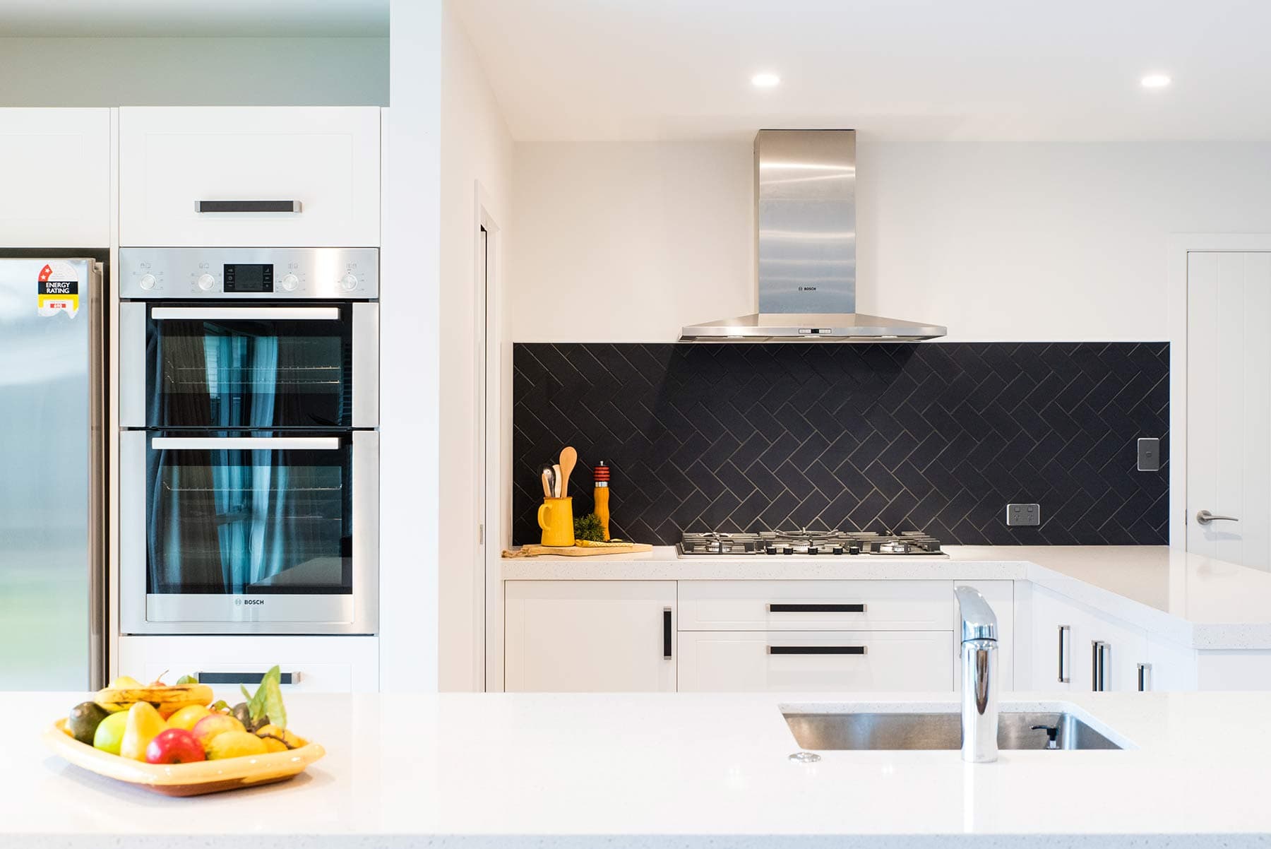 Kitchen with herringbone tiled splashback